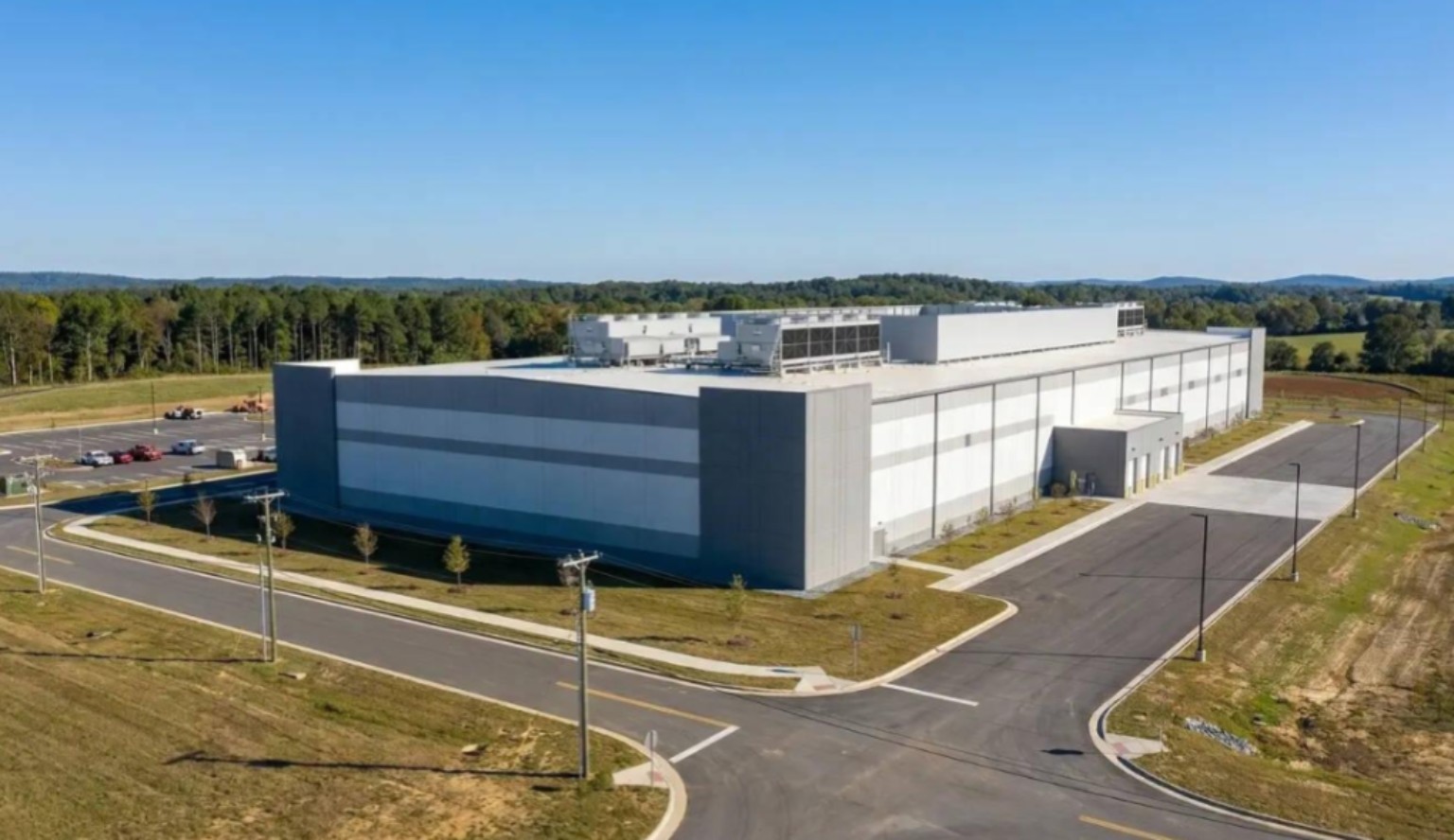 Exterior view of a large data center building and access roads